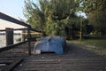 Boat on a wooden pier by the lakeshore next to reeds at sunset