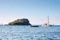 A boat and a yacht anchored near the rabbit island of ancient My