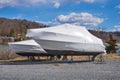 Boat yard in winter with shrink-wrapped boats to protect them from snow and rain