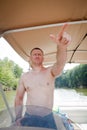 Boater: Man Driving a Boat Pointing Royalty Free Stock Photo