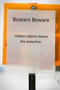 A boaters beware hidden object under water sign