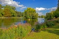 Boaters on lake in park, Birmingham, England