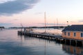 Boathouse and dock in the harbor at dusk Royalty Free Stock Photo