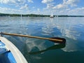 Boating on beautiful lake on blue sky and pleasant green landscape background and lovely reflection on water surface Royalty Free Stock Photo