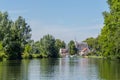 Boating on the river Vecht along the church of Zuilen near Utrecht on summer day Royalty Free Stock Photo