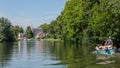 Boating on the river Vecht along the church of Zuilen near Utrecht on summer day Royalty Free Stock Photo