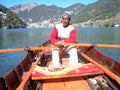 A boatman driving for livelihood at nainital lake. Royalty Free Stock Photo