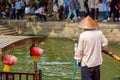 Boatman with paddle near traditional tourist boat on canal of Shanghai Zhujiajiao Old Town in Shanghai, China. Chinese Venice Royalty Free Stock Photo