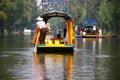 Boatman poling brightly colored boat