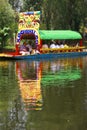 Boatman poling brightly colored boat