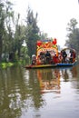 Boatman poling brightly colored boat