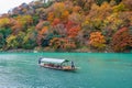 Boatman punting the boat at river. Arashiyama in autumn season along the river in Kyoto, Japan Royalty Free Stock Photo