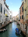 Boats along a canal in Venice, Italy