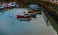Boats anchored in a harbor, in the background stone promenade, s