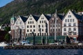 Boats anchored by the historical harbor and wood houses of Bergen, Norway