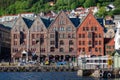 Boats anchored by the historical harbor and wood houses of Bergen, Norway