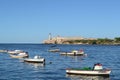 Boats in the Atlantic ocean. View to lighthouse and El morro castle from the seafront