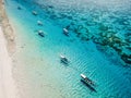 Boats in ocean and beach with white sand on paradise island. Aerial view Royalty Free Stock Photo