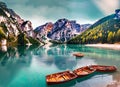 Boats on the Braies Lake Pragser Wildsee in Dolomites mountains. Generated AI Royalty Free Stock Photo