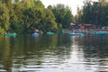 Boats in the brilliant summer water of a beautiful forest lake