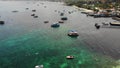 Boats in calm sea in port. Drone view of fishing and dive boats floating on tranquil surface of blue sea in harbor of tropical