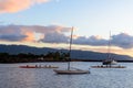 Boats, in a calm sea, at sunset on the north shore of Oahu, Hawaii. Royalty Free Stock Photo