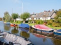 Boats in canal and houses in village of Langwar, Friesland, Netherlands
