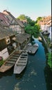 Boats in canal of La Petite Venise or Little Venice in Colmar, Alsace, France. Morning time Aerial Drone Shot Royalty Free Stock Photo