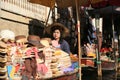 Bangkok Thailand. Boats on the canal selling hats and clothes for tourists in Damnoen Saduak floating market.