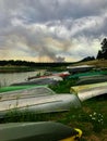Boats and Canoes by a Lake with Smoke from a Forest Fire in Colorado Royalty Free Stock Photo