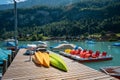 Boats and catamarans on the pier, boat rental for tourists on a lake. A picturesque place for a relaxing holiday Royalty Free Stock Photo