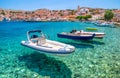 Boats on clear Aegean sea in port of fishing village at island Halki (Chalki) in Greece Royalty Free Stock Photo