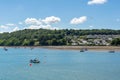 Boats in clear water of Menai Strait and Anglesey island in the background