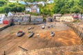 Boats in Clovelly harbour Devon England UK at low tide in HDR