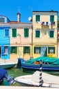 Boats and colorful houses by canal in Burano in Venice Royalty Free Stock Photo