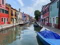 Boats and colorful traditional painted houses in a canal street houses of Burano island Royalty Free Stock Photo