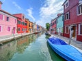 Boats and colorful traditional painted houses in a canal street houses of Burano island Royalty Free Stock Photo