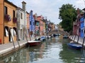 Boats and colorful traditional painted houses in a canal street houses of Burano island Royalty Free Stock Photo