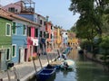 Boats and colorful traditional painted houses in a canal street houses of Burano island, Venice, Italy