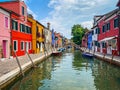 Boats and colorful traditional painted houses in a canal street houses of Burano island Royalty Free Stock Photo