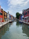 Boats and colorful traditional painted houses in a canal street houses of Burano island, Venice Royalty Free Stock Photo