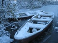 Boats covered in snow on frozen lake Royalty Free Stock Photo