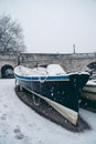 Boats covered in snow and moored on the river in West part of the city