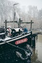 Boats covered in snow and moored on the river in West part of the city