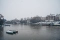 Boats covered in snow and moored on the river in West part of the city