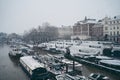 Boats covered in snow and moored on the river in West part of the city