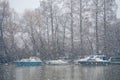 Boats covered in snow and moored on the river in West part of the city