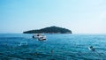 Boats cruising before island at Adriatic sea