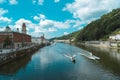 Boats cruising over the Danube river against the city and forest of Passau in Germany