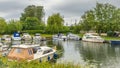 Boats of differing types and sizes line the banks of the River Great Ouse in Ely